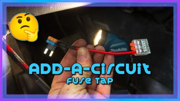 Article image for Add-A-Circuit Fuse Tap. Hand holding the tap, fuses on one end, level connector on the other. WJ floorboard and flashlight in the background. Emoji considering if this is a good product.